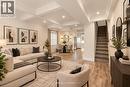 Coffered ceilings, recessed lighting, wood-finish flooring, staircase with wood handrail, and built-in wall shelving - 73 Clinton Street, Hamilton, ON 