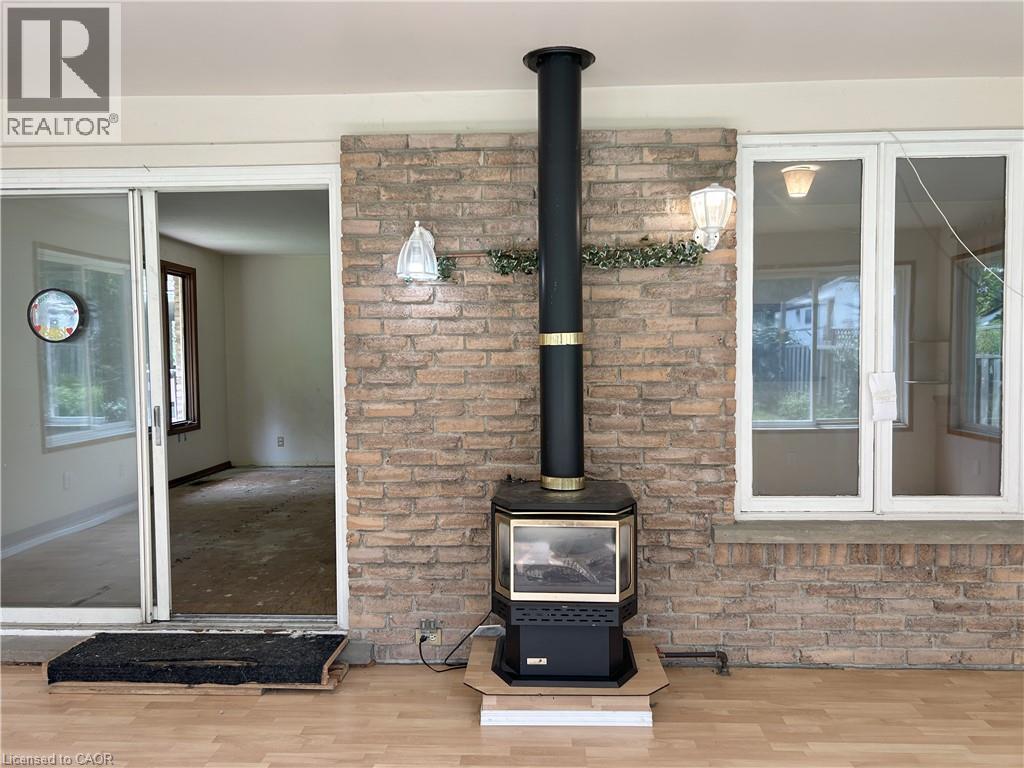 sun room - 90 Queensway E, Simcoe, ON - Indoor Photo Showing Other Room With Fireplace