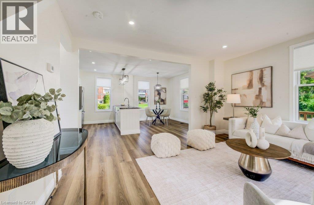 Expansive living area with wood-finish flooring, recessed lighting, and large windows - 185 Strange Street, Kitchener, ON - Indoor Photo Showing Living Room