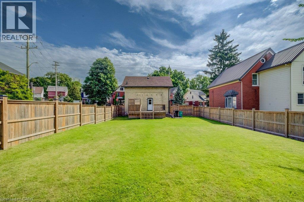 Expansive fenced backyard with a manicured lawn - 185 Strange Street, Kitchener, ON - Outdoor