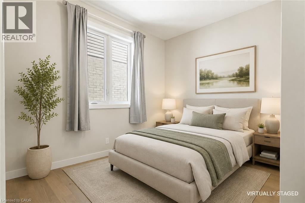 Wide window with louvered blinds, light wood-finish flooring, and light-toned walls - 7966 Fallon Drive Unit# 18, Lucan Biddulph (Twp), ON - Indoor Photo Showing Bedroom
