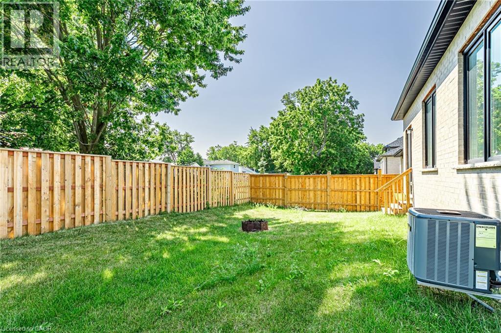 Expansive backyard featuring a manicured lawn, full wood fencing, and mature trees - 7966 Fallon Drive Unit# 18, Lucan Biddulph (Twp), ON - Outdoor