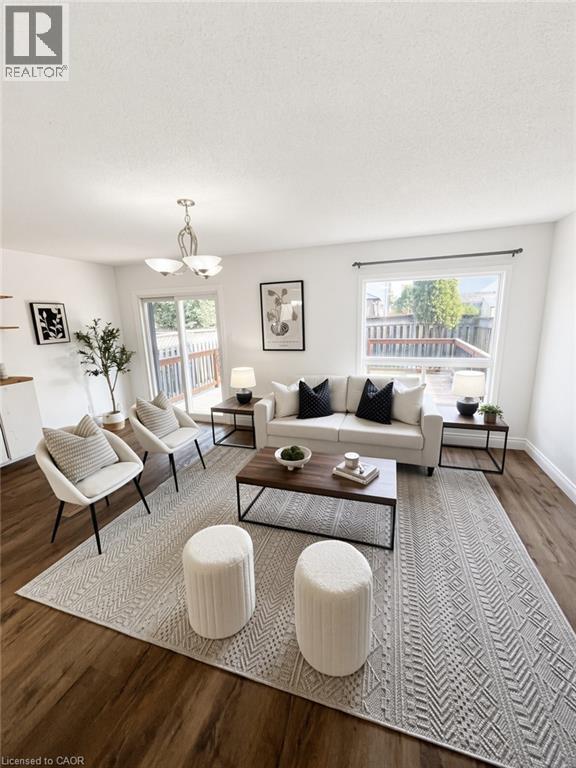 Bright, open living room showcasing hardwood flooring, expansive windows with natural light, and a neutral color palette - 765 Angler Way, Waterloo, ON - Indoor Photo Showing Living Room