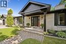 Light-colored brick exterior with black trim, a covered entryway with substantial columns, a paver walkway, an attached garage, and mature landscaping - 267 Abraham Street, Cambridge, ON  - Outdoor 