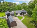Exterior with a light-colored facade, black-trimmed windows, a dark roof, an attached garage, and a paved driveway - 267 Abraham Street, Cambridge, ON  - Outdoor 