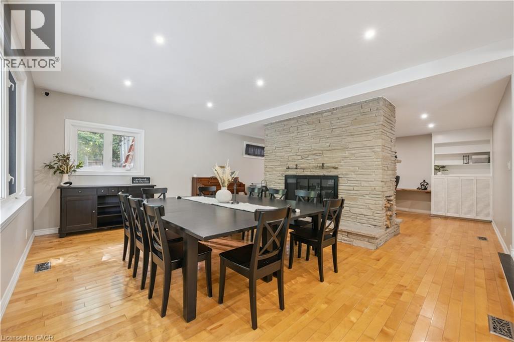 Hardwood flooring, recessed lighting, and a stone-clad fireplace - 267 Abraham Street, Cambridge, ON - Indoor Photo Showing Dining Room