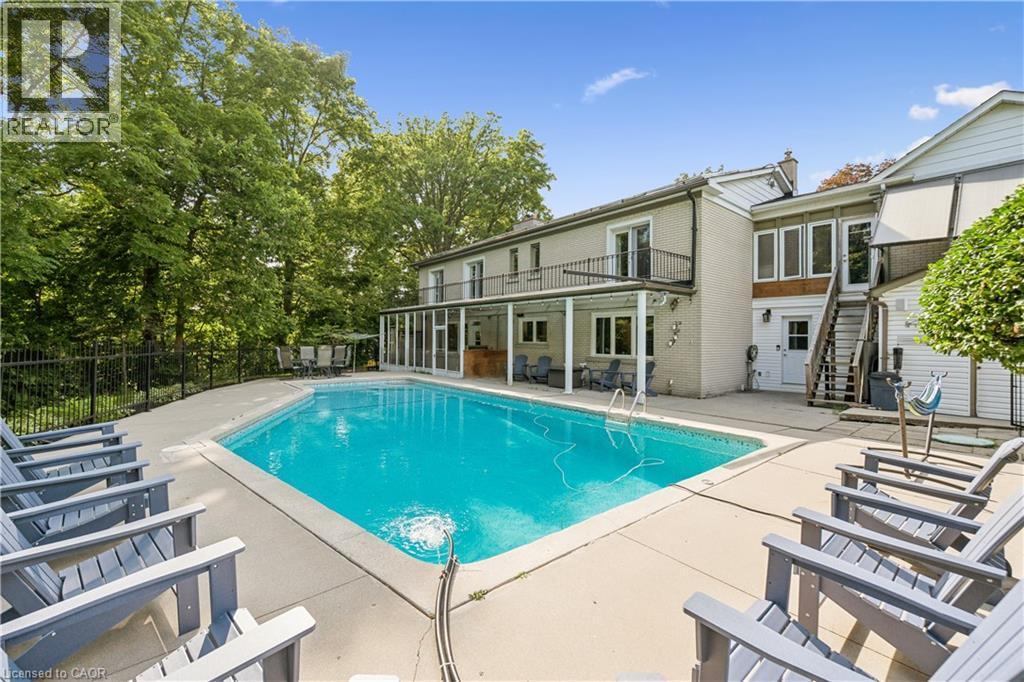 Rectangular in-ground swimming pool with surrounding concrete hardscaping - 267 Abraham Street, Cambridge, ON - Outdoor With In Ground Pool