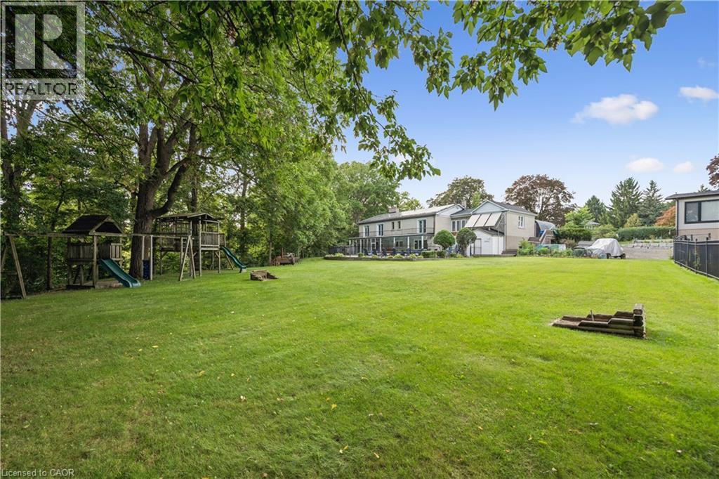 Expansive, manicured lawn with mature trees and a multi-level playset - 267 Abraham Street, Cambridge, ON - Outdoor