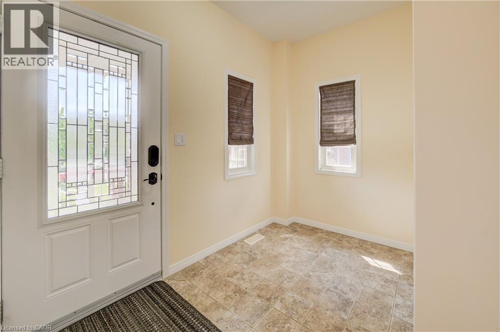 Entryway featuring decorative glass paneled door, two windows with blinds, and linoleum flooring - 64 Kropf Drive, Baden, ON - Indoor Photo Showing Other Room