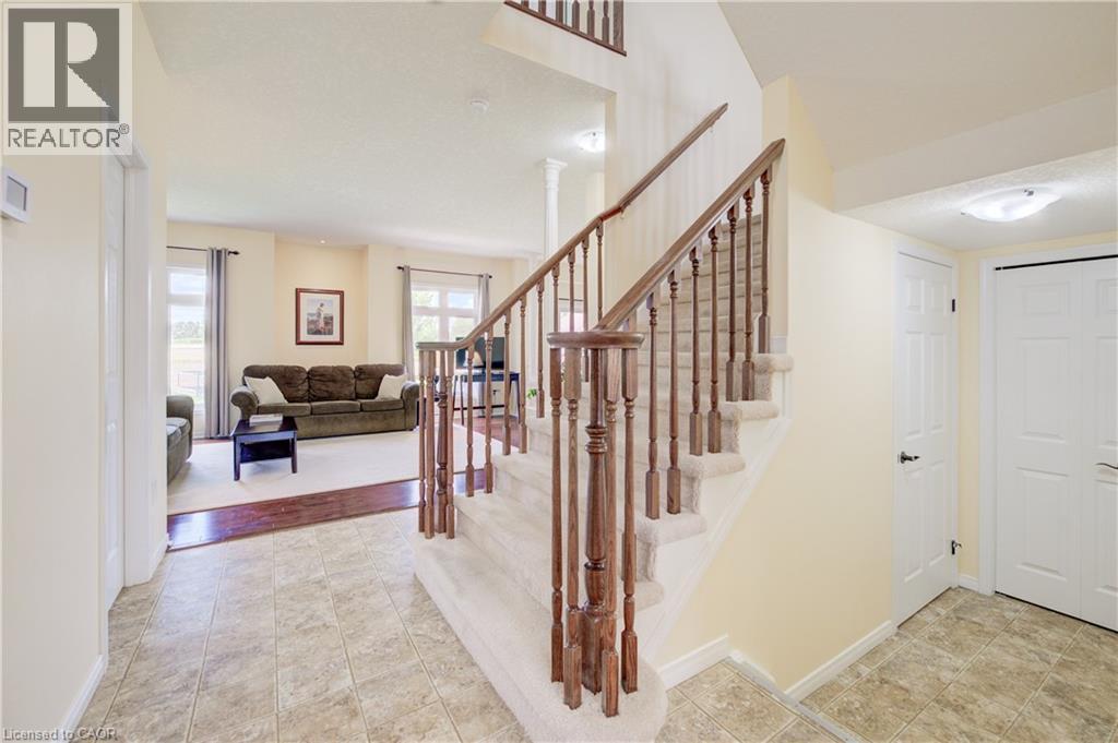 Foyer with Linoleum, carpeted staircase with wood banister, and white paneled doors - 64 Kropf Drive, Baden, ON - Indoor Photo Showing Other Room