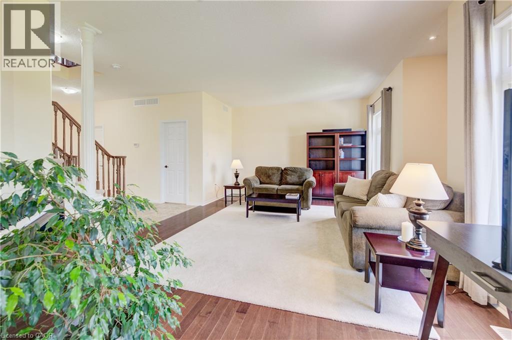 Hardwood flooring, stairway with wood banister and recessed lighting. - 64 Kropf Drive, Baden, ON - Indoor Photo Showing Other Room