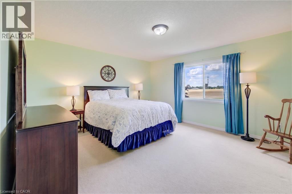 ceiling light, wall-to-wall carpeting, wood-finish bed frame, and window with exterior scenery - 64 Kropf Drive, Baden, ON - Indoor Photo Showing Bedroom