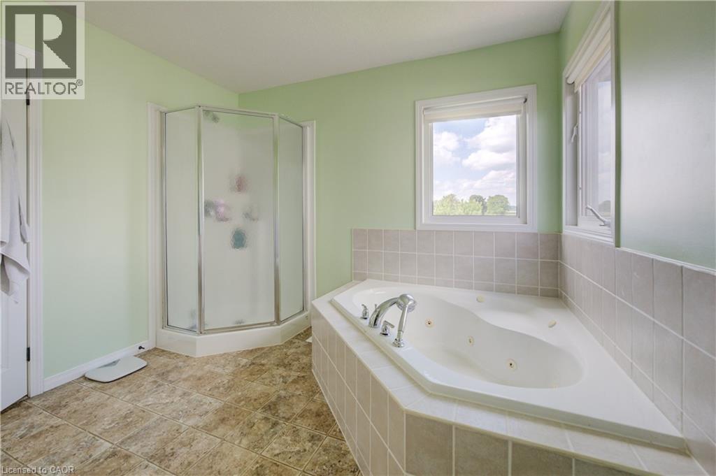 Built-in corner soaking tub with tile surround, separate glass-enclosed shower, and lineoleum flooring - 64 Kropf Drive, Baden, ON - Indoor Photo Showing Bathroom