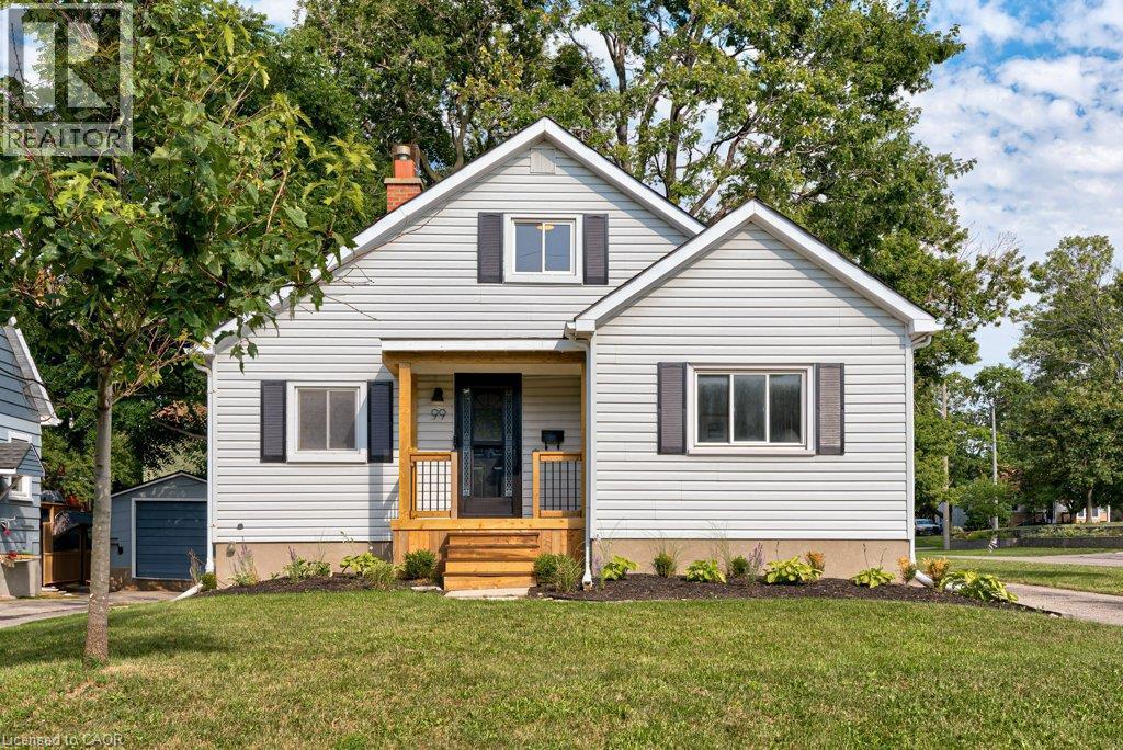 Siding exterior with decorative shutters, covered porch with natural wood elements, and a manicured lawn - 99 Shantz Lane, Kitchener, ON - Outdoor With Facade