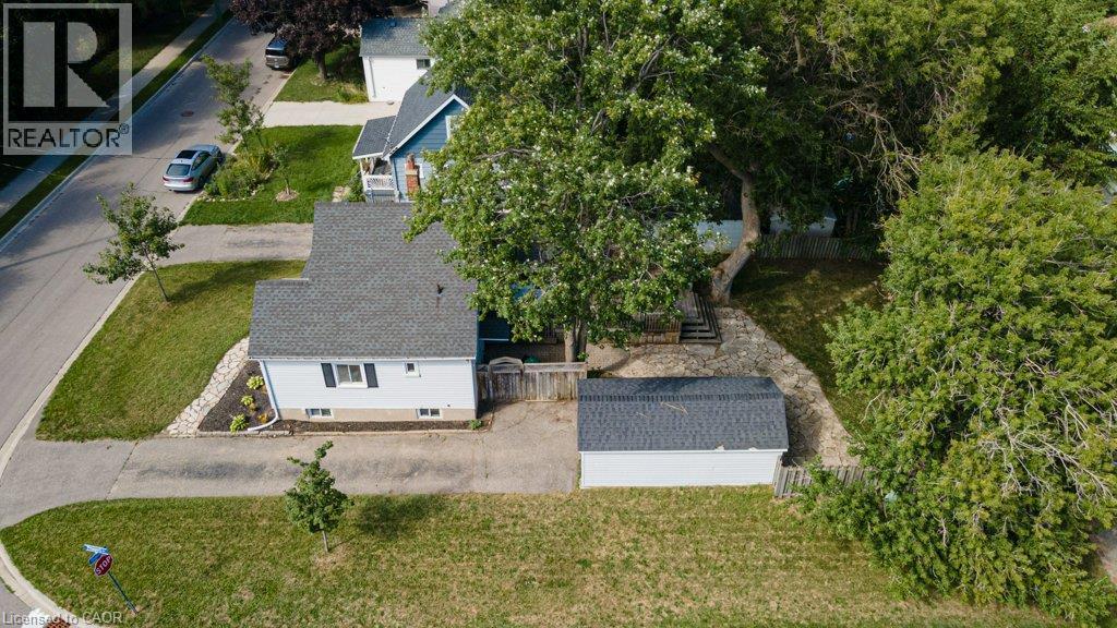 Single-story property with a gray shingle roof, light-colored siding, and a detached shed - 99 Shantz Lane, Kitchener, ON - Outdoor