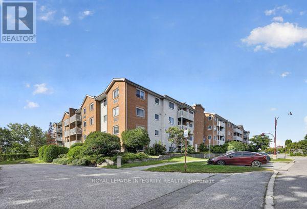 404 - 345 Centrum Boulevard, Ottawa, ON - Outdoor With Balcony With Facade