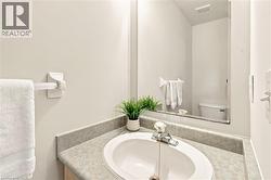Integrated vanity with a white oval sink and a chrome-finish faucet, framed by a full-width mirror - 