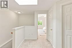 Recessed ceiling light, skylight, carpeted flooring, paneled interior doors, and white painted trim - 