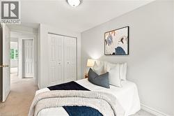 Neutral wall tones, carpeted flooring, and white bi-fold closet doors - 