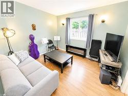 Wood-finish flooring, light-toned wall paint, and a window with natural light -