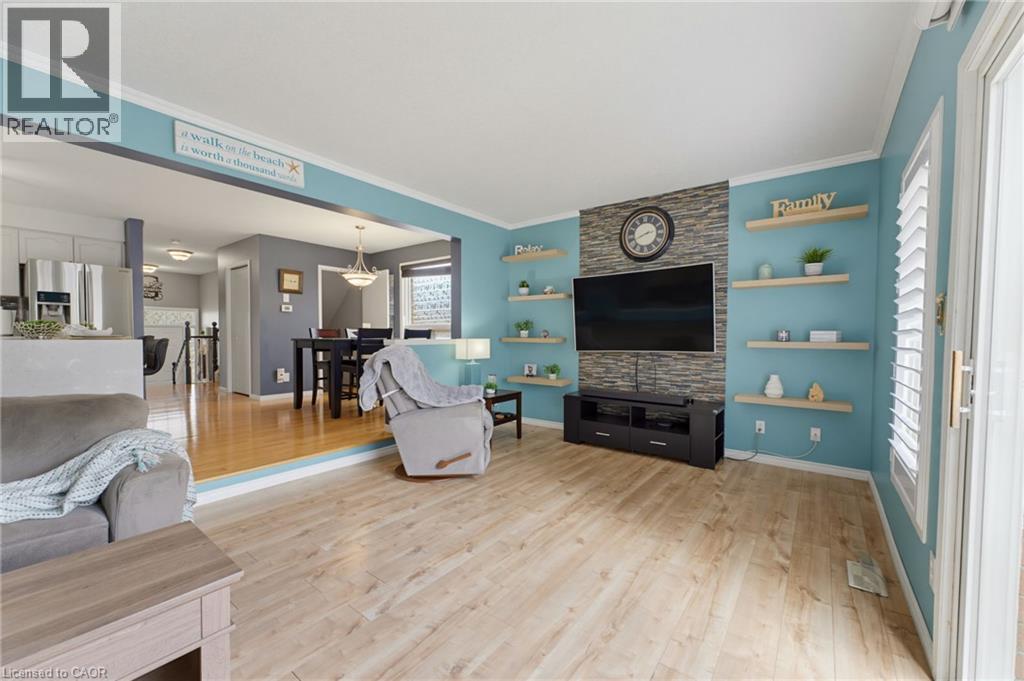 Recessed entertainment wall with stone-finish accent and integrated shelving - 592 Little Dover Crescent, Waterloo, ON - Indoor Photo Showing Living Room