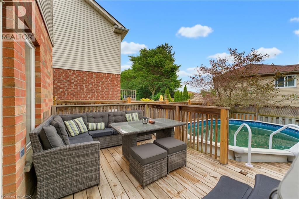 Expansive wood deck with a built-in above-ground pool and wood railing - 592 Little Dover Crescent, Waterloo, ON - Outdoor With Above Ground Pool With Deck Patio Veranda With Exterior