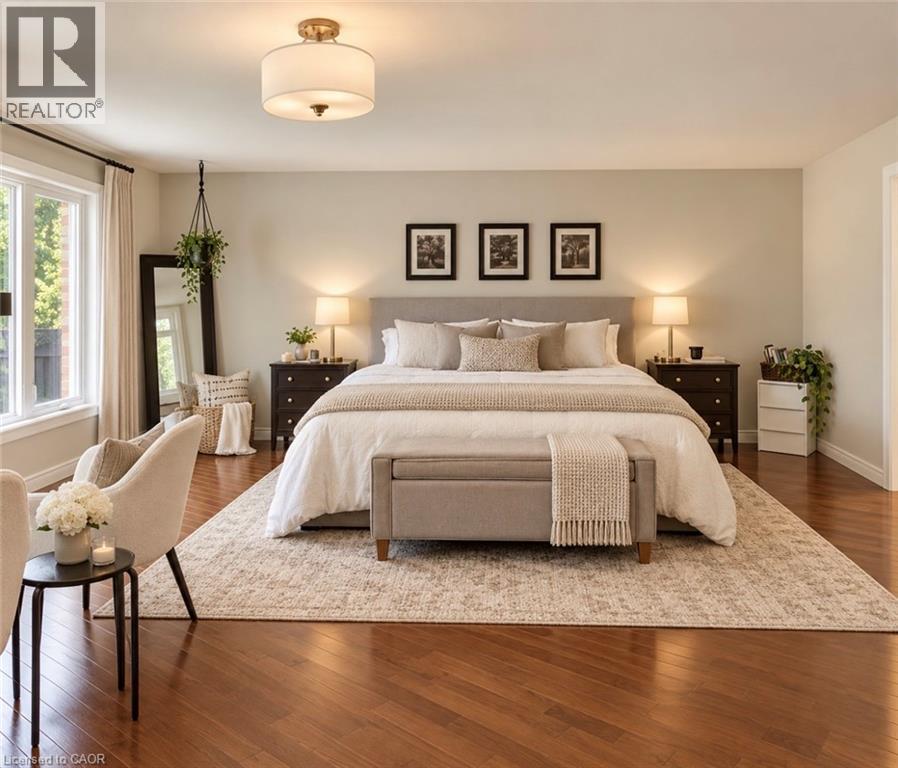 Hardwood flooring throughout, large window with ample natural light, built-in ceiling light fixture, and a spacious layout - 56 Windrush Trail, Kitchener, ON