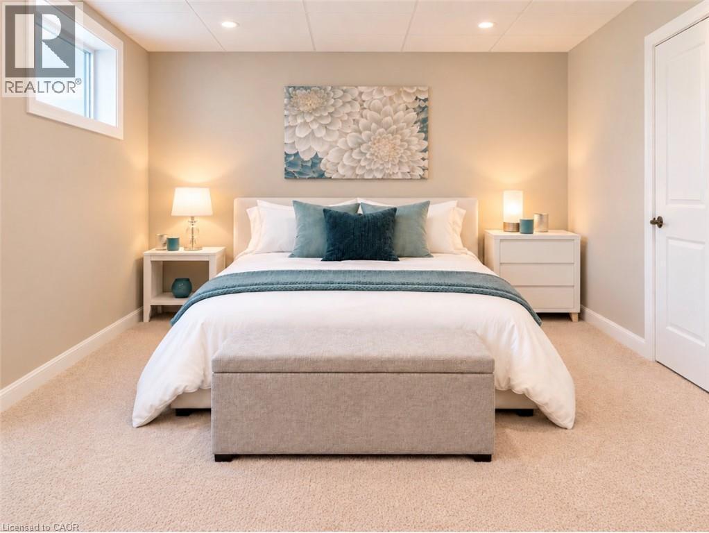 Recessed lighting, light beige carpeting, white trim, and a window - 56 Windrush Trail, Kitchener, ON