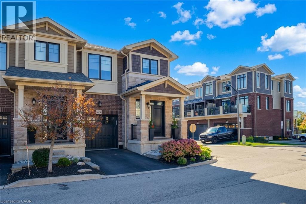 Brick and stone facade with dark trim windows - 65 Waterview Lane, Grimsby, ON