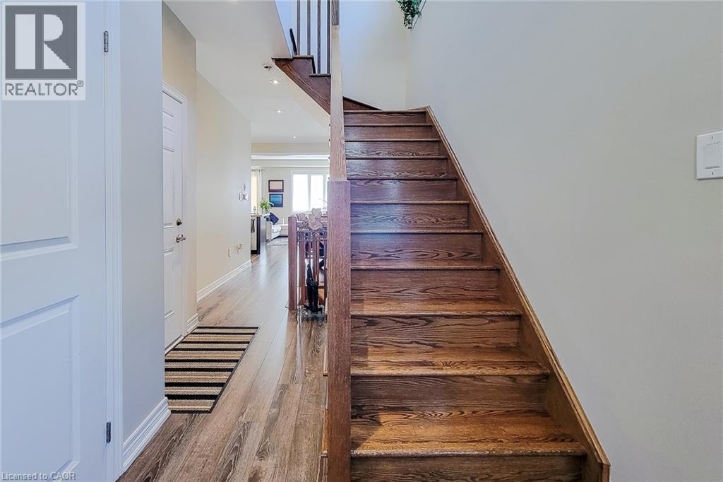Wood-finish flooring throughout the hallway - 65 Waterview Lane, Grimsby, ON