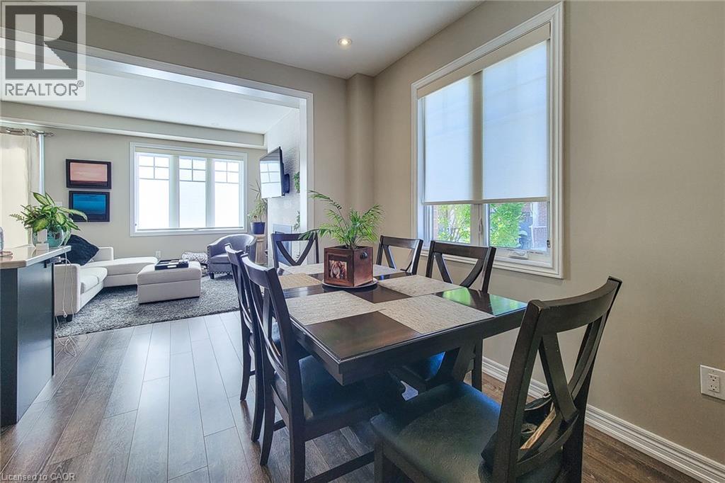 Wood-finish flooring throughout, recessed lighting, and a broad cased opening - 65 Waterview Lane, Grimsby, ON