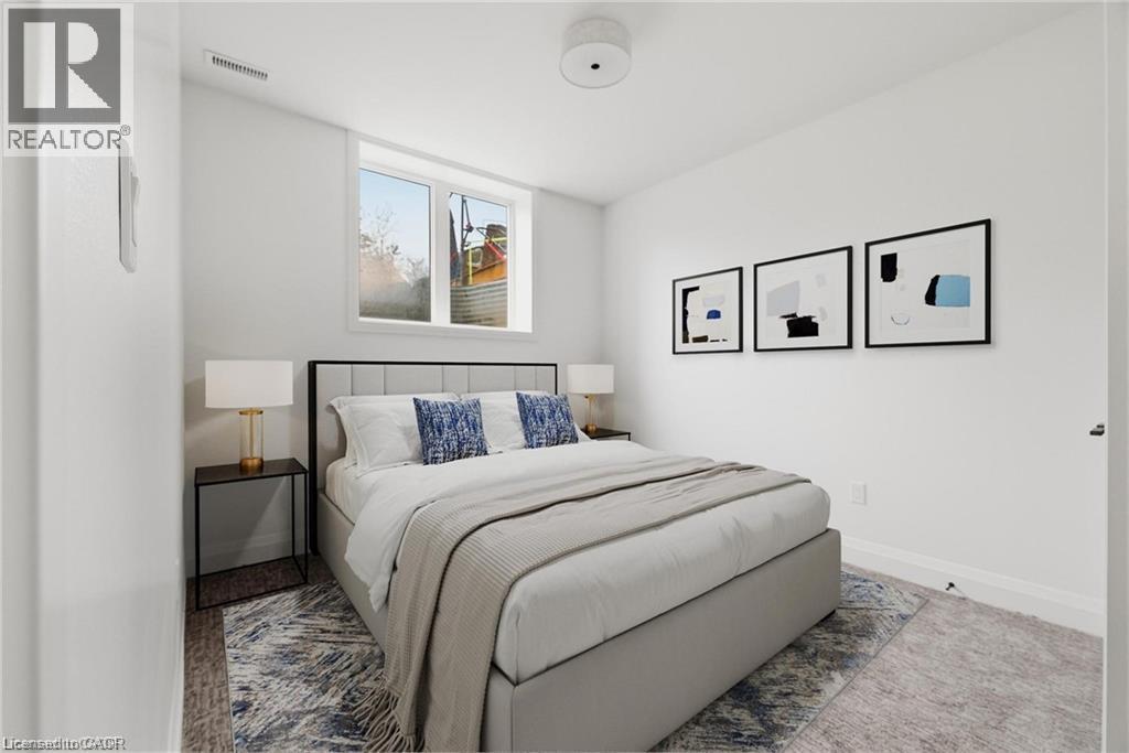 White walls, recessed lighting, and a window providing natural light - 36 Elliott Street Unit# 1, Cambridge, ON