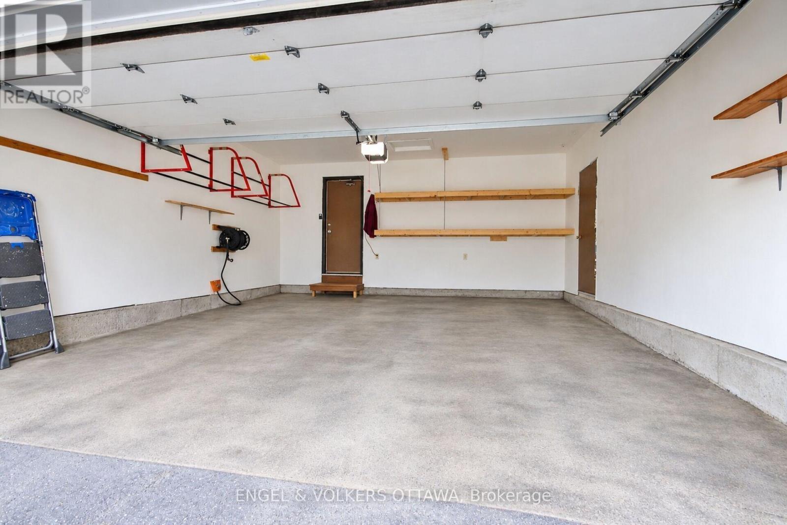 Double car garage with custom shelving. - 24 Tammela Court, Ottawa, ON