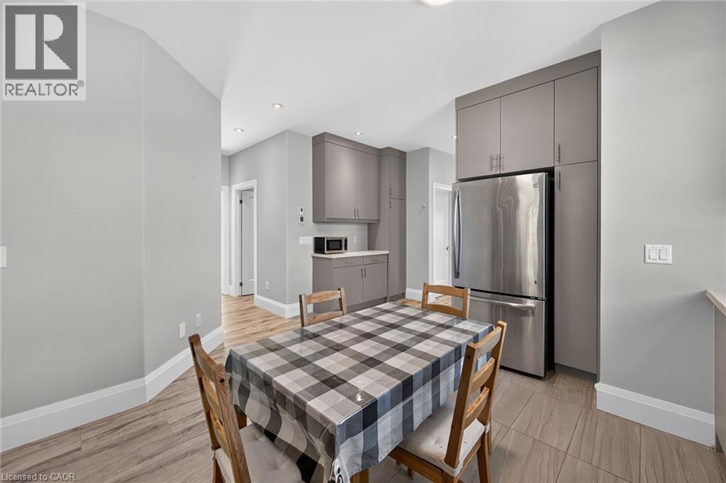 Recessed lighting, wood-finish flooring, stainless steel refrigerator, and built-in cabinetry - 41 Eleanor Avenue, Hamilton, ON