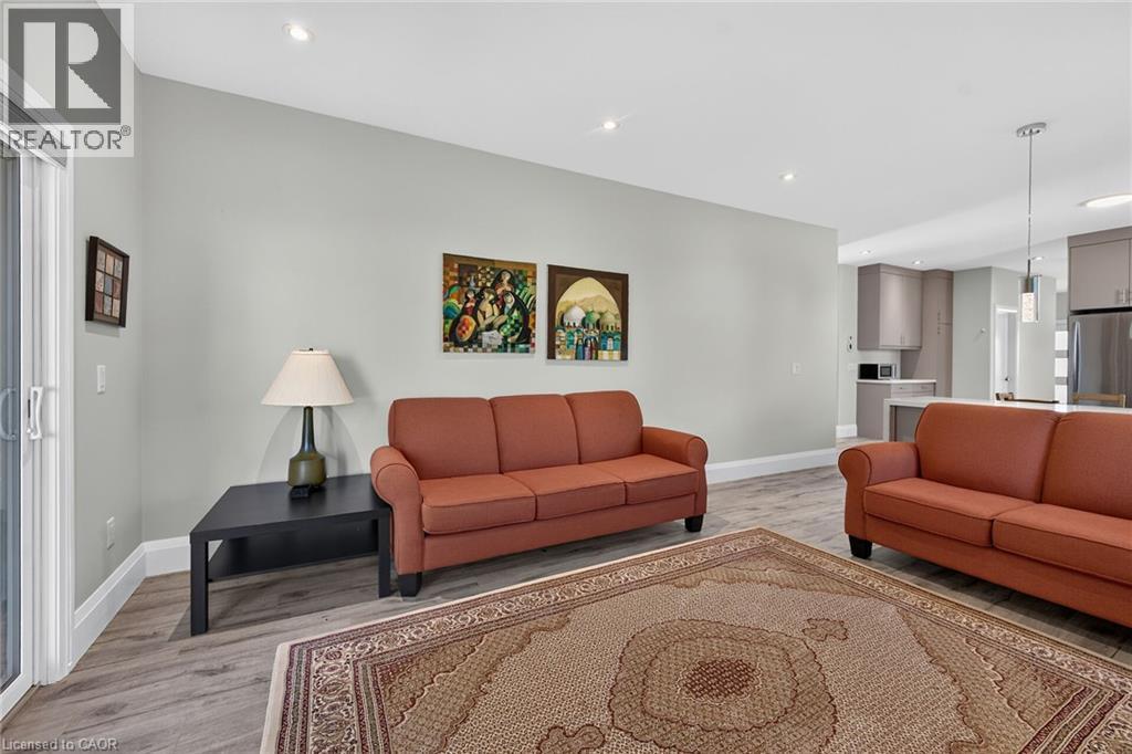 Recessed ceiling lighting, wood-finish flooring, sliding glass door, and a kitchen with stainless steel appliances - 41 Eleanor Avenue, Hamilton, ON