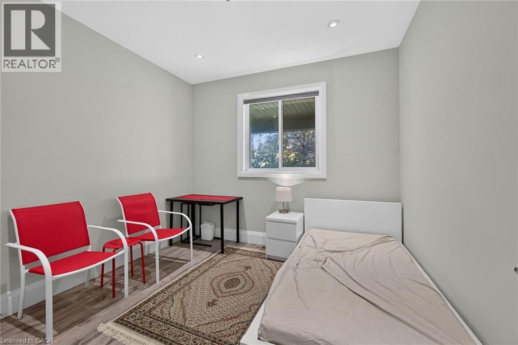 Recessed ceiling lighting, wood-finish flooring, white trim, and a window with white casing - 41 Eleanor Avenue, Hamilton, ON