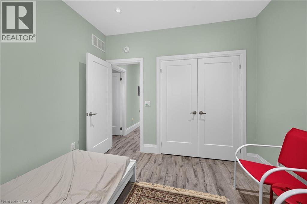 Wood-finish flooring, recessed lighting, and a double-door closet - 41 Eleanor Avenue, Hamilton, ON
