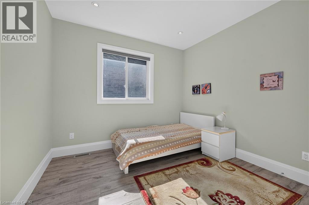 Recessed ceiling lighting, wood-finish flooring, and a window with blinds - 41 Eleanor Avenue, Hamilton, ON