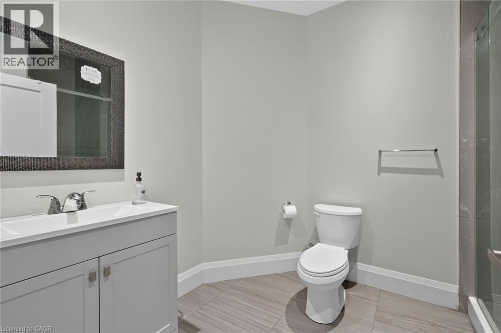 Vanity with a white sink, chrome faucet, and gray cabinetry - 41 Eleanor Avenue, Hamilton, ON