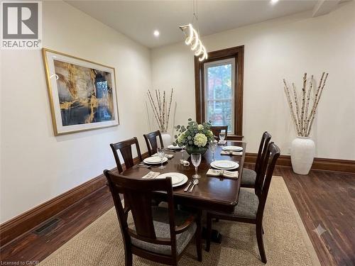 Dining area featuring wood-finish flooring, white walls, and dark wood trim - 245 Lowther Street S, Cambridge, ON 