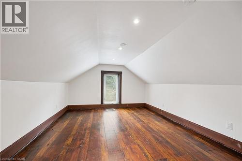 Attic space featuring wood-finish flooring, white walls, and a gabled ceiling with recessed lighting - 245 Lowther Street S, Cambridge, ON 