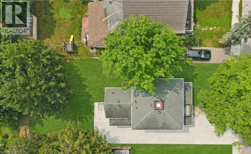 featuring mature trees and 6-7 car paved driveway - 245 Lowther Street S, Cambridge, ON