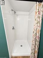 White tile shower surround with a chrome shower head and fixture -