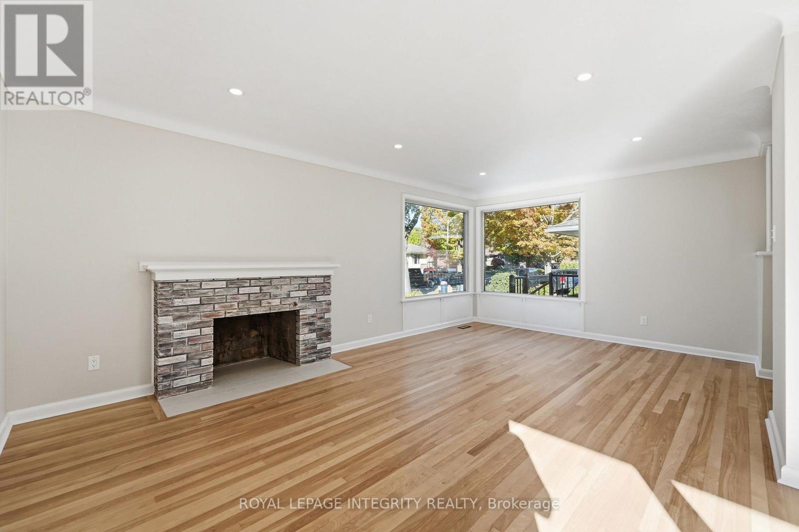Large living room. Fireplace is decorative only. - 2007 Dorval Avenue, Ottawa, ON