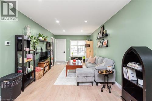 Recessed lighting illuminates the wood-finish flooring - 29 Wexford Avenue N, Hamilton, ON 