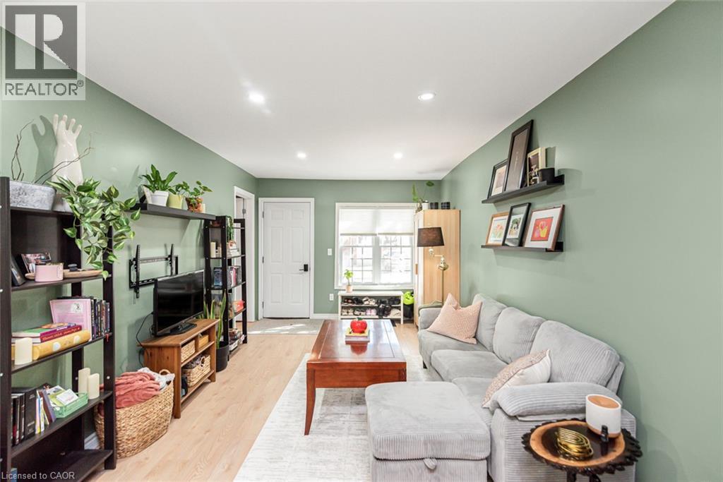 Recessed lighting, light wood-finish flooring, white trim, and a paneled interior door - 29 Wexford Avenue N, Hamilton, ON
