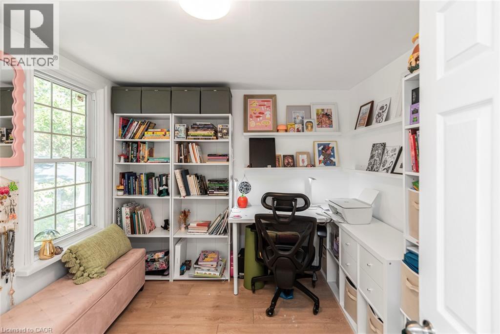 Recessed lighting fixture, wood-finish flooring, built-in shelving, built-in desk, and a double-hung window - 29 Wexford Avenue N, Hamilton, ON