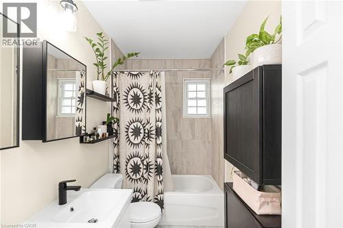 Modern vanity with a rectangular sink and matte black faucet - 29 Wexford Avenue N, Hamilton, ON 