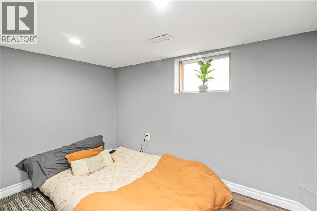 Recessed lighting, wood-finish flooring, and a window with a wood frame - 29 Wexford Avenue N, Hamilton, ON