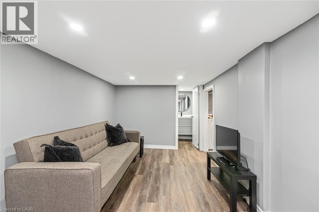 Recessed ceiling lighting, wood-finish flooring, and light gray wall paint - 29 Wexford Avenue N, Hamilton, ON